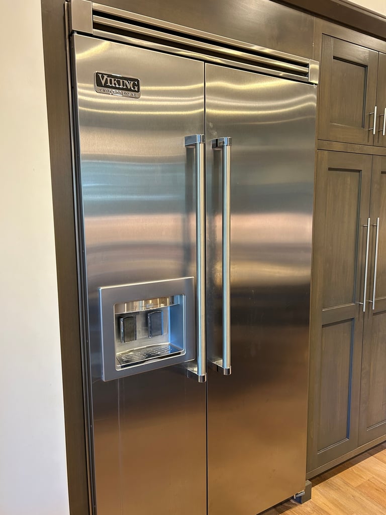 Stainless steel Viking refrigerator with side-by-side doors and ice maker in modern kitchen