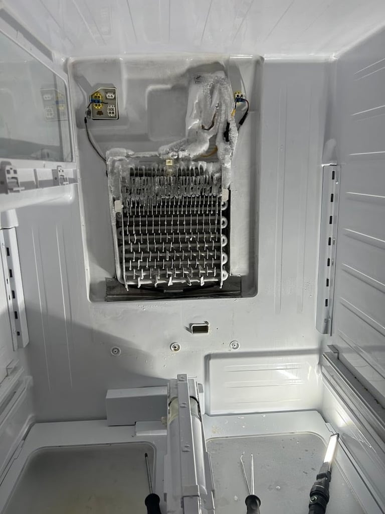 Interior view of open white clothes dryer showing heating element, drum assembly, and wiring components
