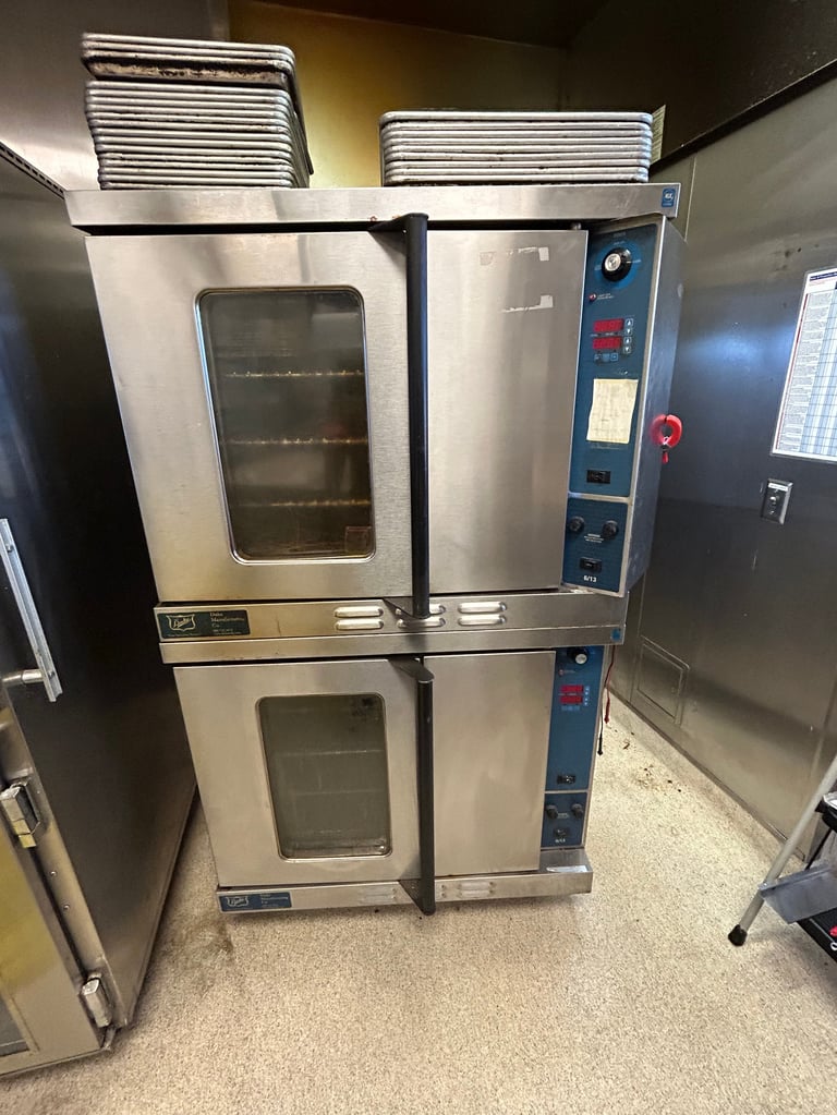 Commercial double-deck convection oven with glass doors and stainless steel exterior in a kitchen